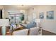 Charming living room with comfortable seating, a balcony, and stylish decor at 4411 46Th W Ave # 201, Bradenton, FL 34210