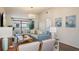 Comfortable living room with a couch, chairs, television and sliding doors to the balcony at 4411 46Th W Ave # 201, Bradenton, FL 34210
