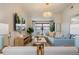 Comfortable living room with a couch, chairs, television and sliding doors to the balcony at 4411 46Th W Ave # 201, Bradenton, FL 34210