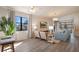 Bright living room with large windows, light wood floors, and stylish decor, creating a comfortable and inviting atmosphere at 4411 46Th W Ave # 201, Bradenton, FL 34210