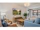 Inviting living room with large TV, neutral furniture and bright lighting at 4411 46Th W Ave # 201, Bradenton, FL 34210