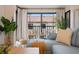Comfortable seating area with outdoor view and natural light from sliding glass doors to outdoor balcony at 4411 46Th W Ave # 201, Bradenton, FL 34210
