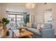 Comfortable living room with a couch, chairs, television and sliding doors to the balcony at 4411 46Th W Ave # 201, Bradenton, FL 34210