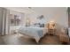 Cozy bedroom with a queen-sized bed, decorative pillows, and a view to outdoor balcony at 4411 46Th W Ave # 201, Bradenton, FL 34210