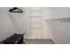 A bright walk-in closet with shelving, a rack, and a laundry basket with black liners at 4411 46Th W Ave # 201, Bradenton, FL 34210