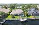 Aerial view of property showcasing backyard pool, boat dock, lush landscaping and canal front views at 4735 Starboard Dr, Bradenton, FL 34208