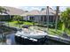 Aerial view of a boat lift and a boat on a canal with lush landscaping and beautiful houses at 4735 Starboard Dr, Bradenton, FL 34208