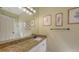 Bathroom featuring a large mirror, granite countertop, and ample lighting at 4735 Starboard Dr, Bradenton, FL 34208