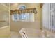 Bathroom featuring a soaking tub and glass door shower at 4735 Starboard Dr, Bradenton, FL 34208