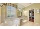 Bright bathroom with tile floors, granite countertops and soaking tub with window at 4735 Starboard Dr, Bradenton, FL 34208
