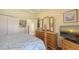 Well lit bedroom featuring wood floors, dresser with mirror, and view of entry at 4735 Starboard Dr, Bradenton, FL 34208