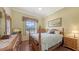 Comfortable bedroom featuring wood floors, natural light, and traditional furnishings at 4735 Starboard Dr, Bradenton, FL 34208