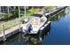 Boat on a boat lift with a canal view of the waterfront community, showcasing boating and waterfront living at 4735 Starboard Dr, Bradenton, FL 34208
