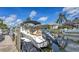 Close up of a boat docked on a canal with a view of lush landscaping and beautiful homes at 4735 Starboard Dr, Bradenton, FL 34208