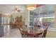 Spacious dining area with a large table, ceiling fan, and view of the lanai and pool at 4735 Starboard Dr, Bradenton, FL 34208