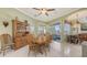 Inviting dining area with a wooden dining set, built-in cabinet, and views to an outdoor patio at 4735 Starboard Dr, Bradenton, FL 34208