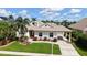 Lovely one-story home with a well-kept lawn, inviting walkway, charming carport and lush tropical landscaping at 4735 Starboard Dr, Bradenton, FL 34208
