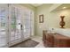 Bright foyer featuring neutral tile flooring, a decorative table, and door to the backyard at 4735 Starboard Dr, Bradenton, FL 34208