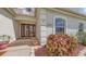 Inviting front entrance with double doors, decorative potted plants and beautiful surrounding landscaping at 4735 Starboard Dr, Bradenton, FL 34208