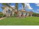 Charming home with lush landscaping, manicured lawn, and decorative flower beds at 4735 Starboard Dr, Bradenton, FL 34208