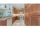 Functional kitchen featuring white appliances, granite countertops, tile floors and ample cabinet space at 4735 Starboard Dr, Bradenton, FL 34208