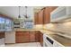 Bright kitchen with wooden cabinetry, granite countertops, and open access to the living area at 4735 Starboard Dr, Bradenton, FL 34208
