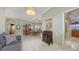 Open-plan living space with tile flooring, a comfortable gray sofa, and view to the dining area at 4735 Starboard Dr, Bradenton, FL 34208