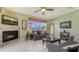Bright living room with tile fireplace, ceiling fan, tile floors, and sliding doors to the pool at 4735 Starboard Dr, Bradenton, FL 34208