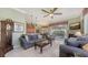 Inviting living room with a fireplace, tile floors, ceiling fan, and sliding glass doors to the pool at 4735 Starboard Dr, Bradenton, FL 34208