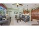 Living room open to the kitchen with tile floors, high ceilings, and access to the lanai at 4735 Starboard Dr, Bradenton, FL 34208