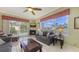 Bright living room features a fireplace, tile floors, ceiling fan, and sliding glass doors to the lanai at 4735 Starboard Dr, Bradenton, FL 34208