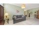 Inviting living room with a comfortable gray sofa, tile flooring, and serene decor at 4735 Starboard Dr, Bradenton, FL 34208