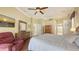 Main bedroom featuring ceiling fan, wood floors and ensuite bathroom at 4735 Starboard Dr, Bradenton, FL 34208