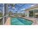 Enclosed pool with clear blue water, stone surround, and outdoor seating area perfect for entertaining at 4735 Starboard Dr, Bradenton, FL 34208