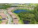 Aerial view of new construction homes surrounding a peaceful lake in a gated community at 491 Daylily Blvd, Nokomis, FL 34275