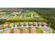 Aerial view of new construction homes with mature trees and ponds in a quiet neighborhood at 491 Daylily Blvd, Nokomis, FL 34275