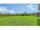 Expansive backyard featuring well-maintained lawn and serene natural backdrop at 491 Daylily Blvd, Nokomis, FL 34275