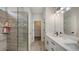 Bathroom featuring dual sinks, a glass-enclosed shower, and contemporary finishes that offers a spa-like experience at 491 Daylily Blvd, Nokomis, FL 34275