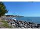 Rocky beach with views of a coastal city skyline and calm ocean waters at 491 Daylily Blvd, Nokomis, FL 34275