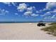 A sprawling beach scene with an ATV, surfboard, and calming ocean waters awaits beachgoers at 491 Daylily Blvd, Nokomis, FL 34275