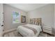 Bright bedroom showcases window views; stylishly decorated with neutral tones, maximizing comfort and aesthetic appeal at 491 Daylily Blvd, Nokomis, FL 34275