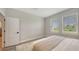 Well-lit bedroom with two windows offering lovely green views; showcases a minimalist aesthetic, ideal for relaxation at 491 Daylily Blvd, Nokomis, FL 34275