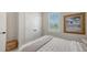 Cozy bedroom featuring a window, a decorative picture, and a comfortable bed with stylish bedding at 491 Daylily Blvd, Nokomis, FL 34275