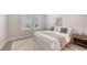 Comfortable bedroom featuring large windows and a plush rug, creating a cozy and inviting atmosphere at 491 Daylily Blvd, Nokomis, FL 34275