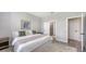 Bright bedroom with neutral walls, minimalist decor, ensuite bathroom, and natural light creates a peaceful retreat at 491 Daylily Blvd, Nokomis, FL 34275