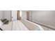 A spacious bedroom showcases hardwood flooring, a walk-in closet, and soothing neutral color palette at 491 Daylily Blvd, Nokomis, FL 34275