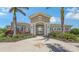Stunning clubhouse entrance with lush landscaping, columns, and tile roof at 491 Daylily Blvd, Nokomis, FL 34275