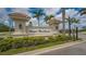 Venice Woodlands entrance sign with manicured landscaping and blue skies at 491 Daylily Blvd, Nokomis, FL 34275