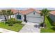 Beautiful single-story home with well-manicured lawn, landscaping, tile roof, and paver driveway at 491 Daylily Blvd, Nokomis, FL 34275