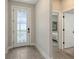 Bright foyer with decorative door, neutral paint, and tile floors with bedroom visible at 491 Daylily Blvd, Nokomis, FL 34275